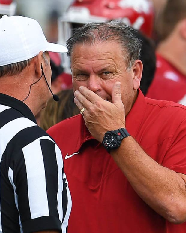 Razorbacks coach Sam Pittman talking with an official during a game at Razorback Stadium